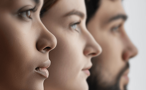 Close-up profile view of three diverse individuals looking forward.